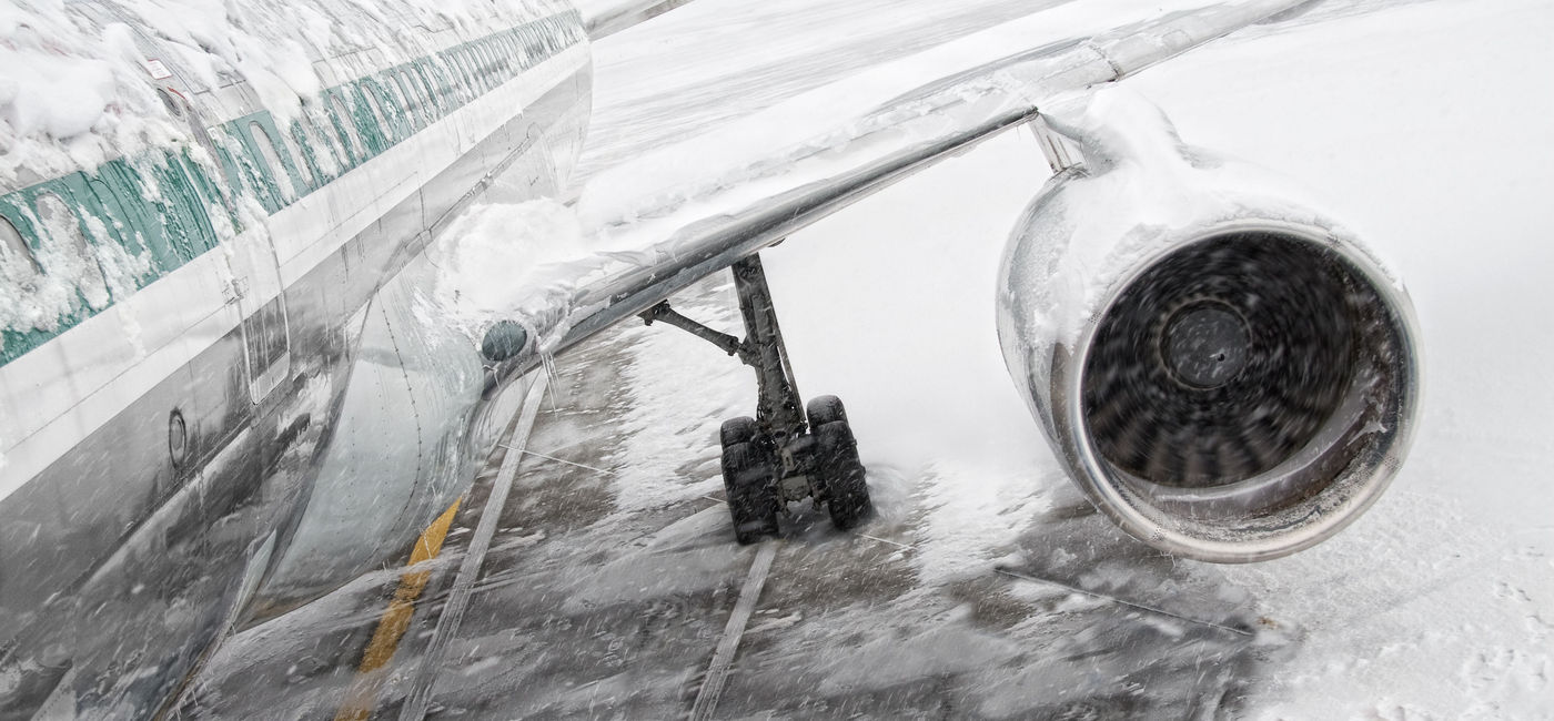 Image: Airplane covered in snow and ice during a winter storm. (Photo via iStock/Getty Images Plus/nycshooter)
