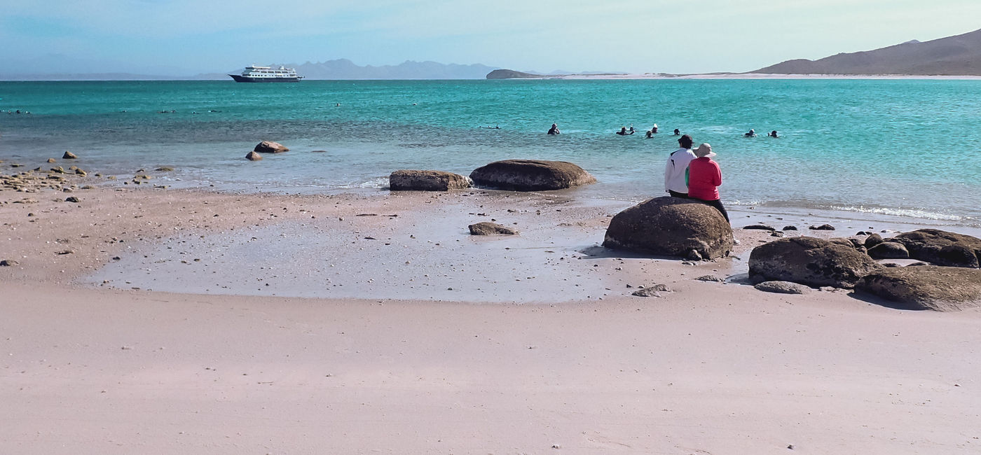 Image: A couple on an UnCruise Adventures enjoys the beach in Baja, Mexico. (photo via UnCruise Adventures) (Photo Credit: (photo via UnCruise Adventures))