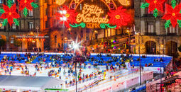 Mexico City Zocalo Christmas night celebration at ice skating rink.