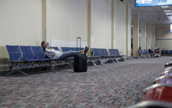 Woman waiting at empty airport.