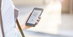 Businesswoman using mobile ride share app