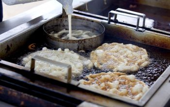 A vender making funnel cakes at a state fair