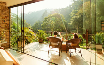 Couple relaxing in the chairs at hotel balcony.