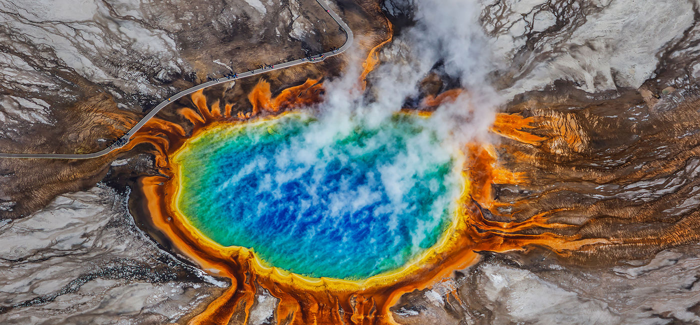 Image: PHOTO: Aerial view of the Grand Prismatic Spring in Yellowstone National Park. (photo via Ajith Kumar/iStock/Getty Images Plus)