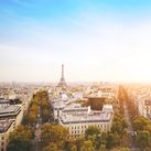 airplane flying over cityscape of Paris with Eiffel Tower (Photo via anyaberkut / iStock / Getty Images Plus)