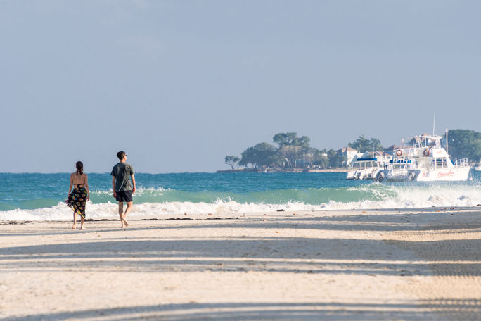 Couple walking Seven Mile Beach in Negril, Jamaica