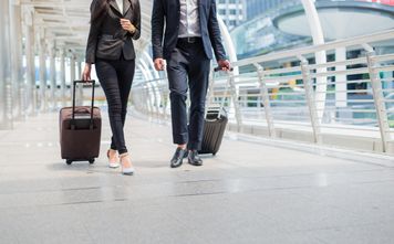 Travelers walking together with luggage