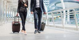 Travelers walking together with luggage