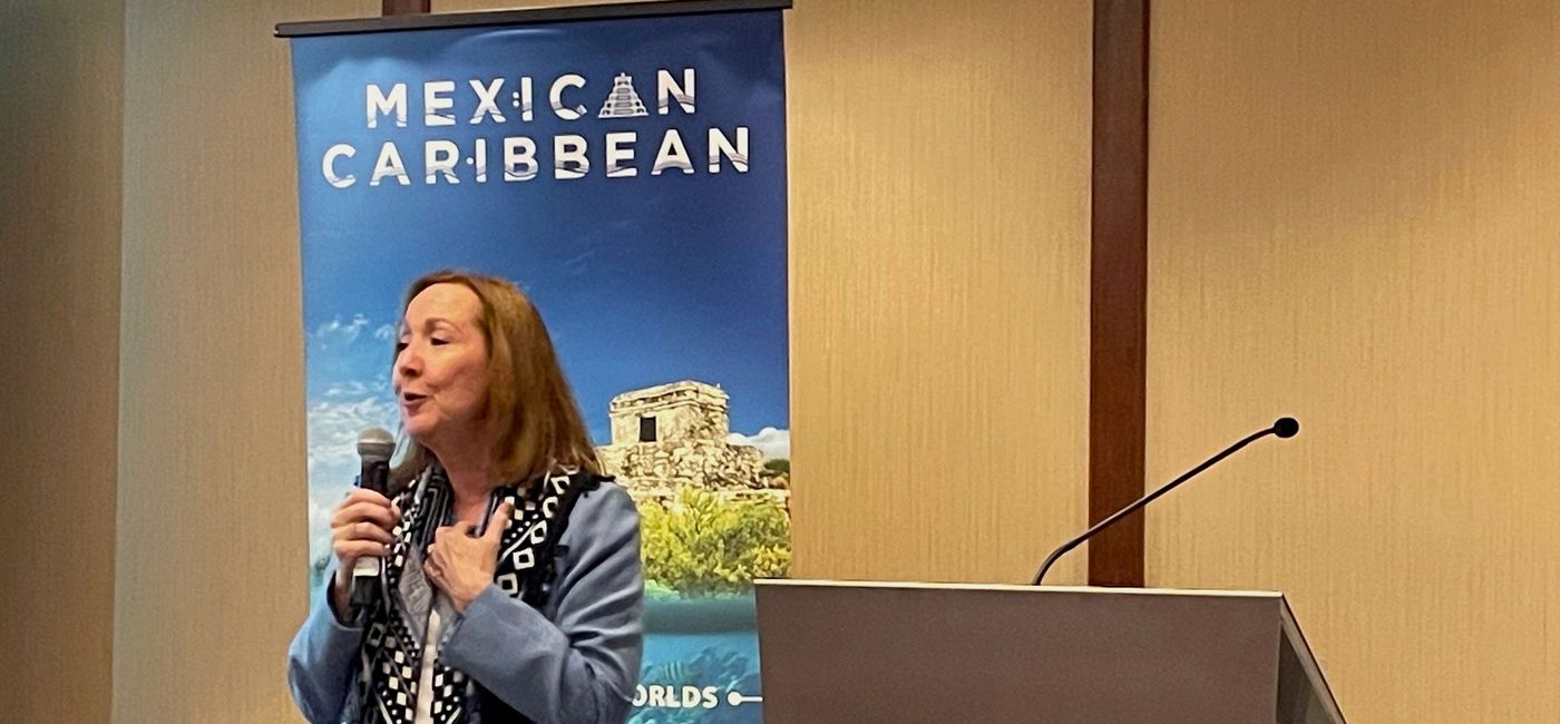 Image: Lizzie Cole, executive director of promotion for the tourism board of Quintana Roo, speaks to an enthusiastic audience of travel advisors in Toronto. (Bruce Parkinson)