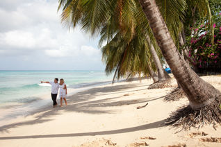 Couple walking on the beach in Barbados