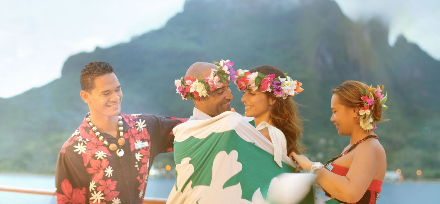 Image: Honeymooners are wrapped in a traditional Polynesian taififi blanket onboard a Paul Gauguin itinerary. (photo via Paul Gauguin Cruises) ((photo via Paul Gauguin Cruises))