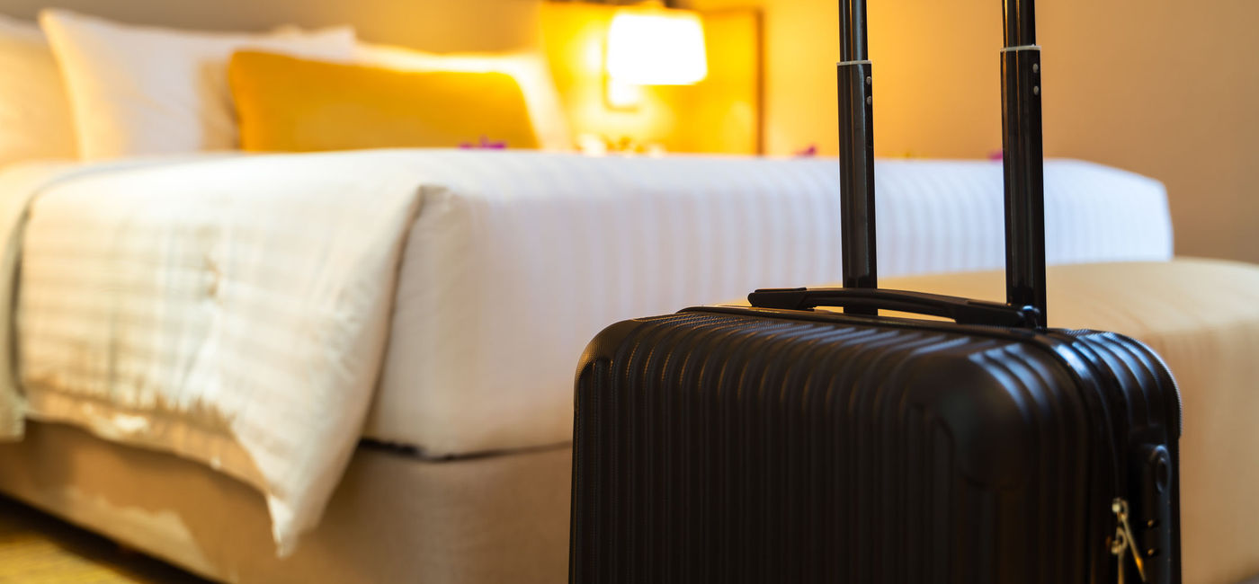 Photo: Suitcase in hotel room. (photo via structuresxx / iStock / Getty Images Plus)