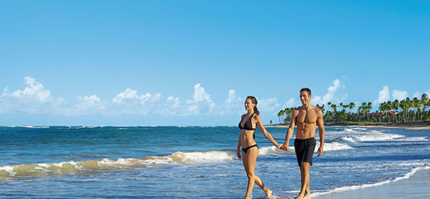 Image: PHOTO: A couple strolling on the beach at Breathless Punta Cana Resort & Spa. (photo via AMResorts)