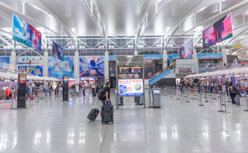 Travelers checking in at New York&#39;s John F Kennedy International Airport