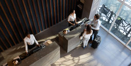 People checking in at hotel.