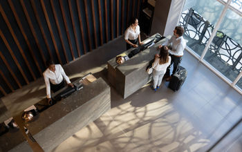 People checking in at hotel.