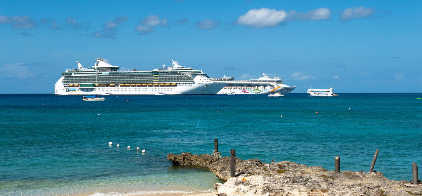 Image: Cruise ships off of George Town, Cayman Islands. (photo via gabrielasauciuc/iStock Editorial/Getty Images Plus)