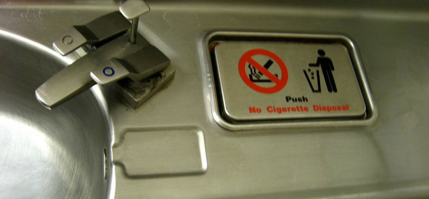 Image: PHOTO: An airplane bathroom with cigarette disposal warning. (Photo via Flickr/Jason Lander) 