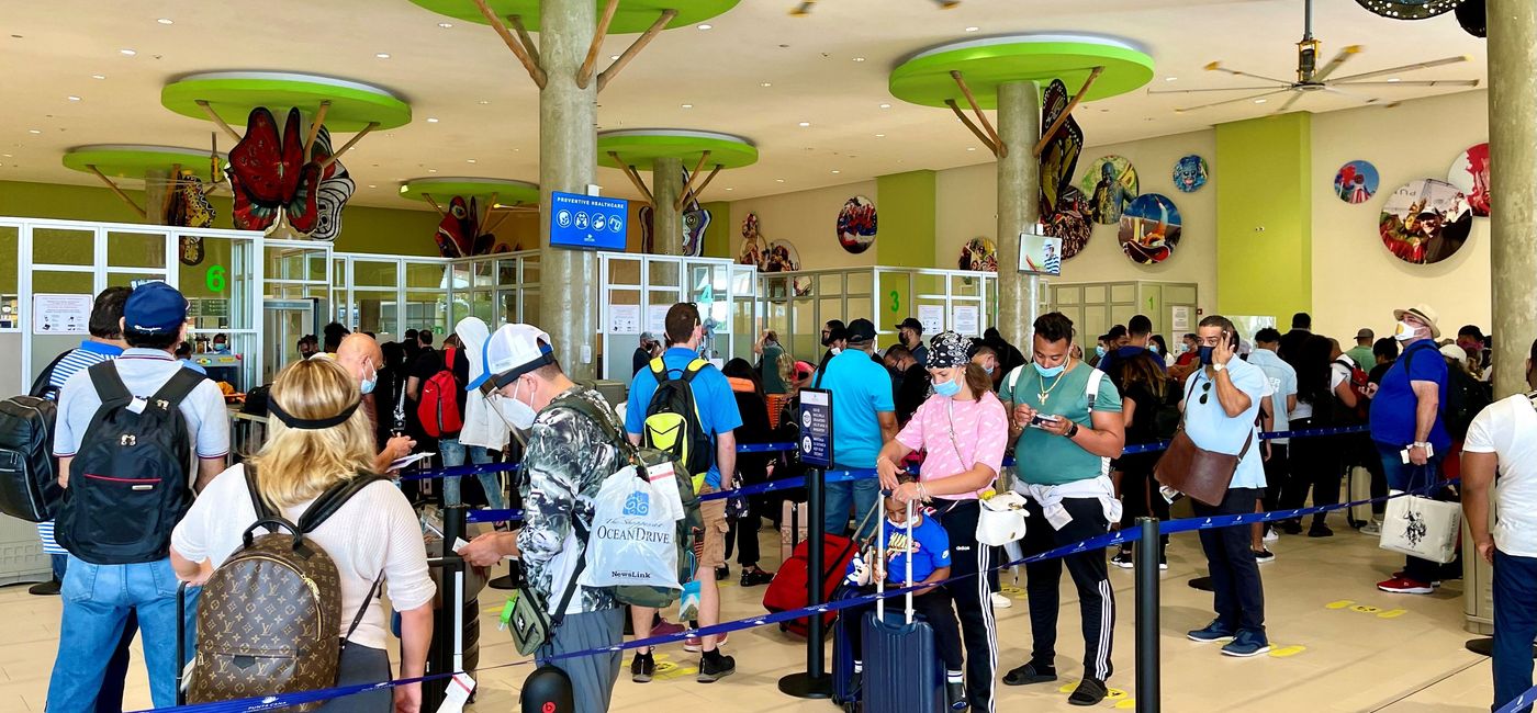 Image: Travelers adhering to airport guidelines of wearing masks and following floor markers. (photo by Codie Liermann)