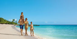 Family walks on the beach
