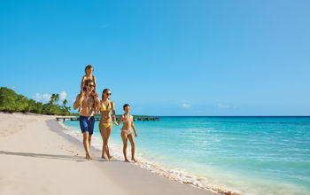 Family walks on the beach