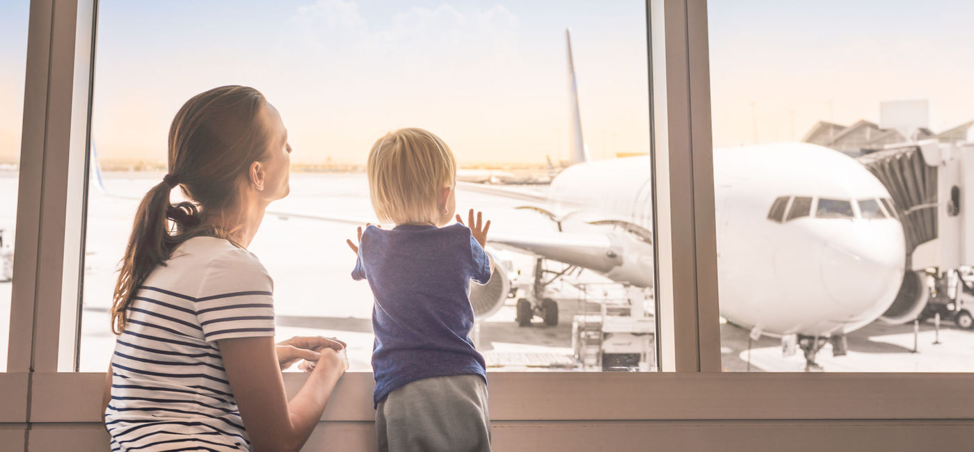 Image: PHOTO: Mother and son at the airport. (Photo via Getty Images Plus / iStock / keiferpix)