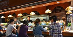 Customers at a tapas bar at La Boqueria market in Barcelona, Spain