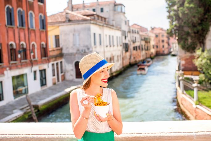 Traveler enjoying Italian street food in Venice Traveler enjoying Italian street food in Venice