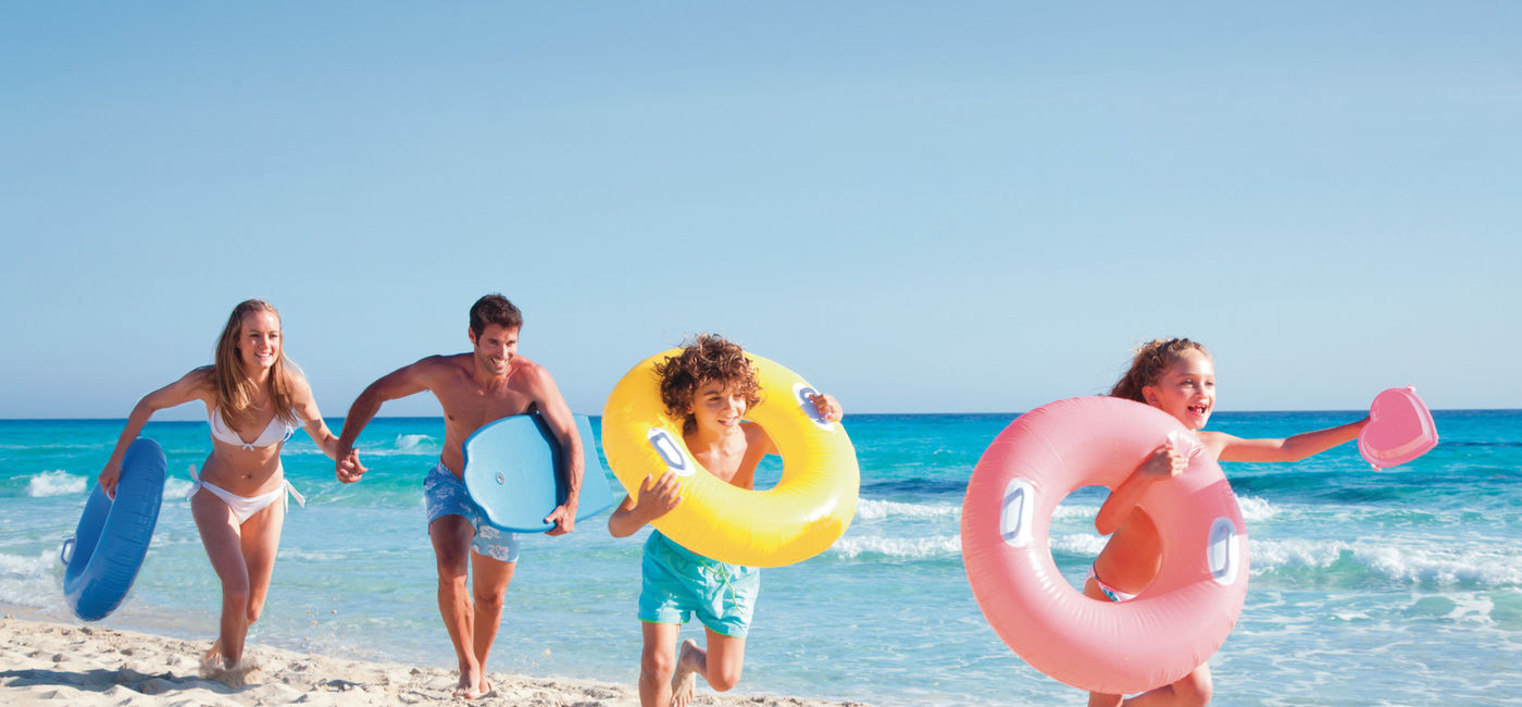 Image: Family enjoying the beach in Punta Cana. (photo courtesy of RIU Hotels & Resorts) (Photo Credit: Riu Hotels & Resorts)