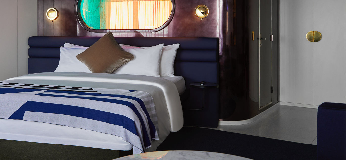 Image: A king bed in a RockStar Suite aboard a Virgin Voyages ship. (photo via Virgin Voyages) ((photo via Virgin Voyages))