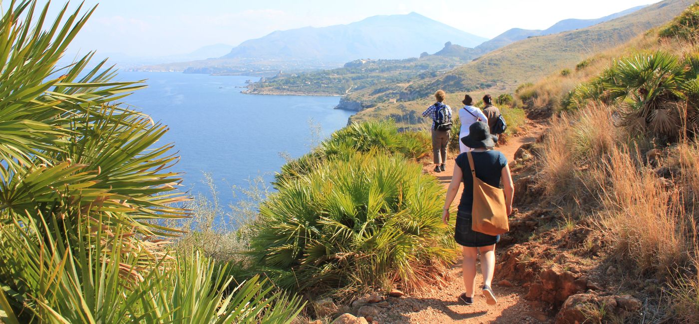 Image: A group walks along the coastline of Sicily in Italy. (photo via Intrepid Travel)