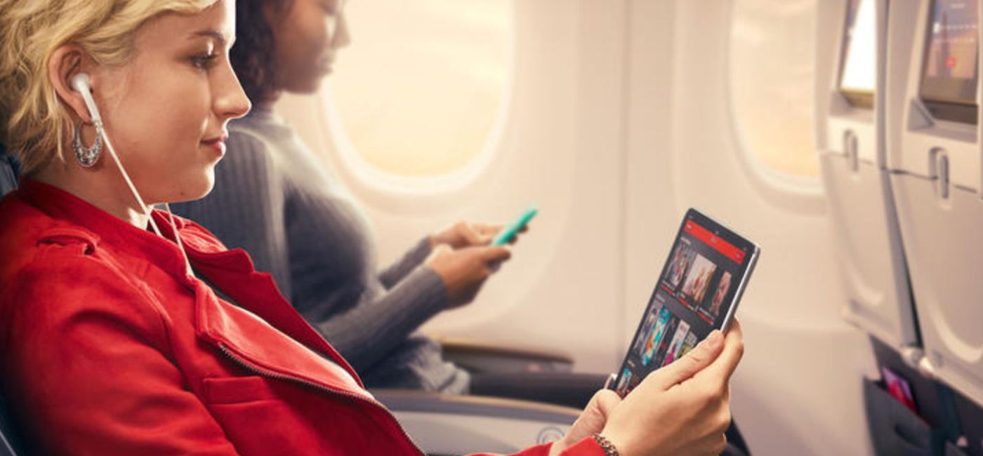 Image: Traveler using wi-fi onboard Delta Air Lines plane (photo courtesy Delta Air Lines)