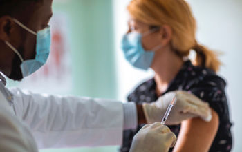 Young woman getting vaccinated against COVID-19.