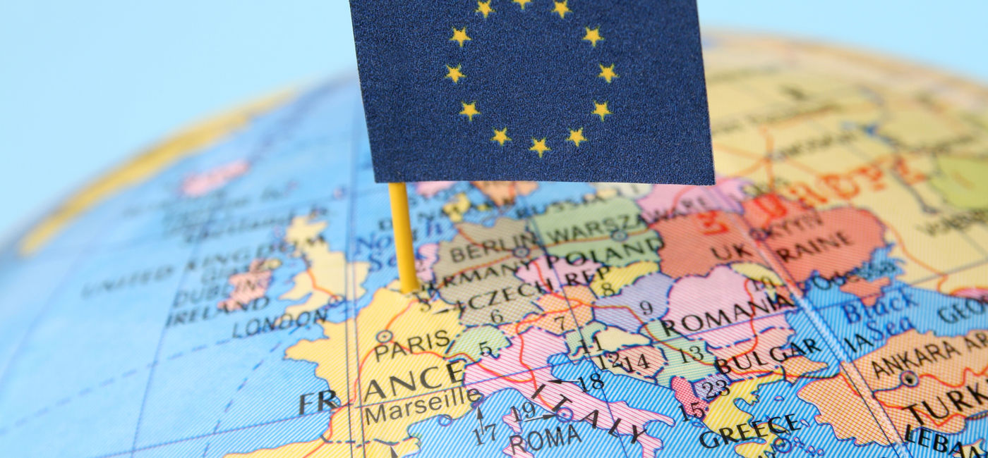 Image: European Union flag over a map of the region. (photo via iStock/Getty Images E+/FotografiaBasica)