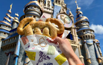 Mickey pretzel wrapped in celebratory paper at Magic Kingdom