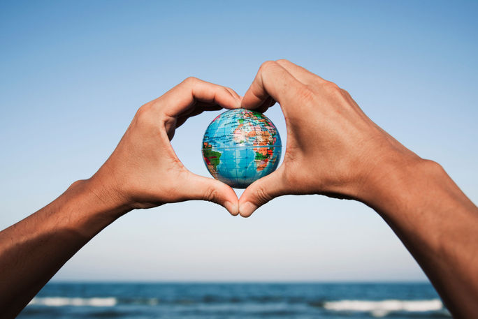 A young man with a world globe in his hands A young man with a world globe in his hands