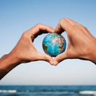 A young man with a world globe in his hands