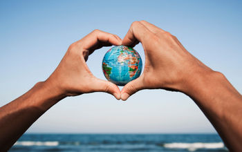 A young man with a world globe in his hands