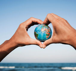 A young man with a world globe in his hands