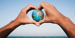A young man with a world globe in his hands