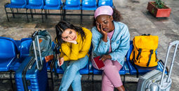 Frustrated travelers waiting at a railway station 