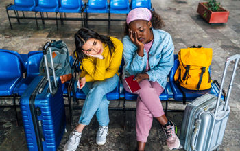 Frustrated travelers waiting at a railway station 