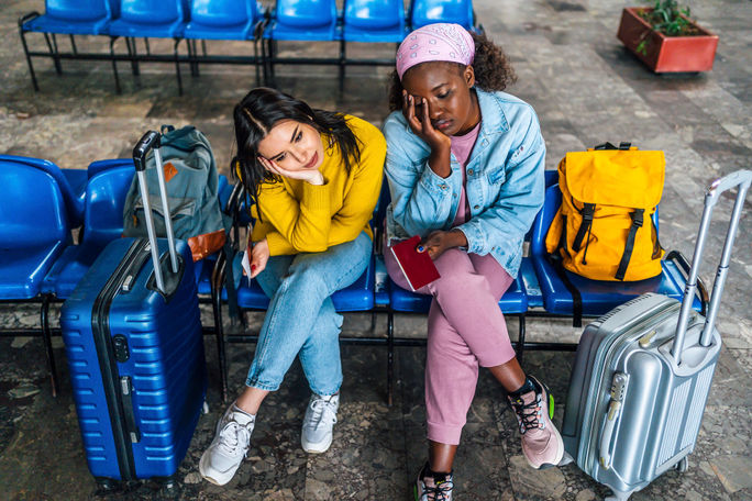 Frustrated travelers waiting at a railway station 