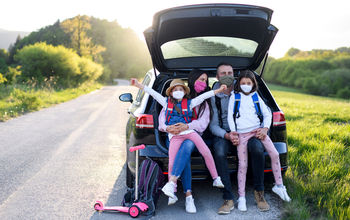 Family on a road trip in masks