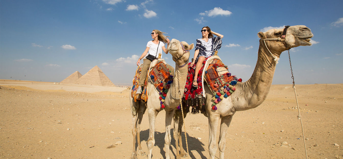 Image: Guests riding camels near the Great Pyramid of Giza, Egypt. (photo courtesy Emily Slade Photography/A&K) (Emily Slade Photography)