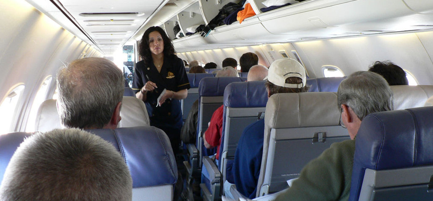 Image: PHOTO: A flight attendant talking to passengers. (photo via Flickr/Rick Kimpel)