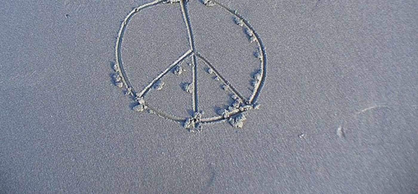 Image: PHOTO: Peace symbol in sand. (photo via Flickr/Karyn Christner)
