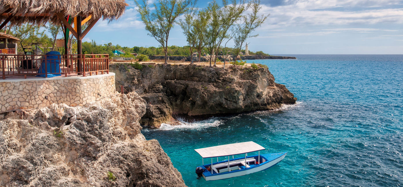 Image: Rocky beach in Negril, Jamaica. (photo via lucky-photographer/iStock/Getty Images Plus)