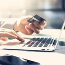 Man on laptop with credit card