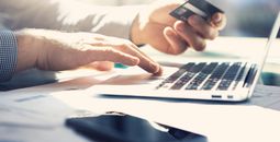 Man on laptop with credit card